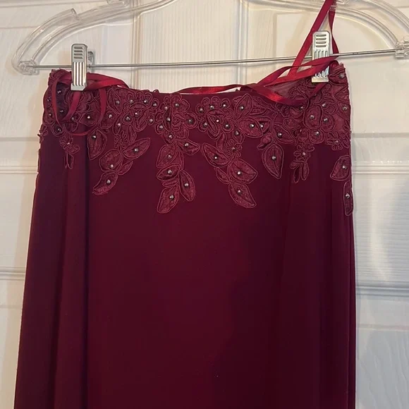 This prom dress is Burgundy, a size 2 with corset straps in the back. Worn once